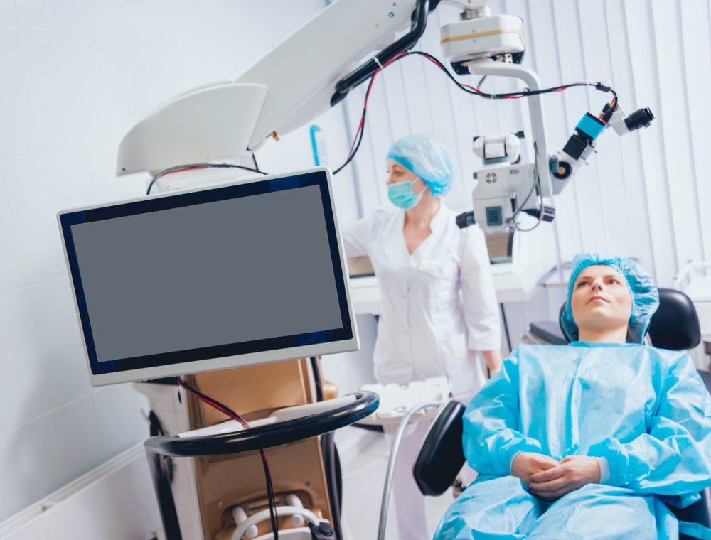 Woman being prepared for her PRK treatment, sitting in an operating chair.